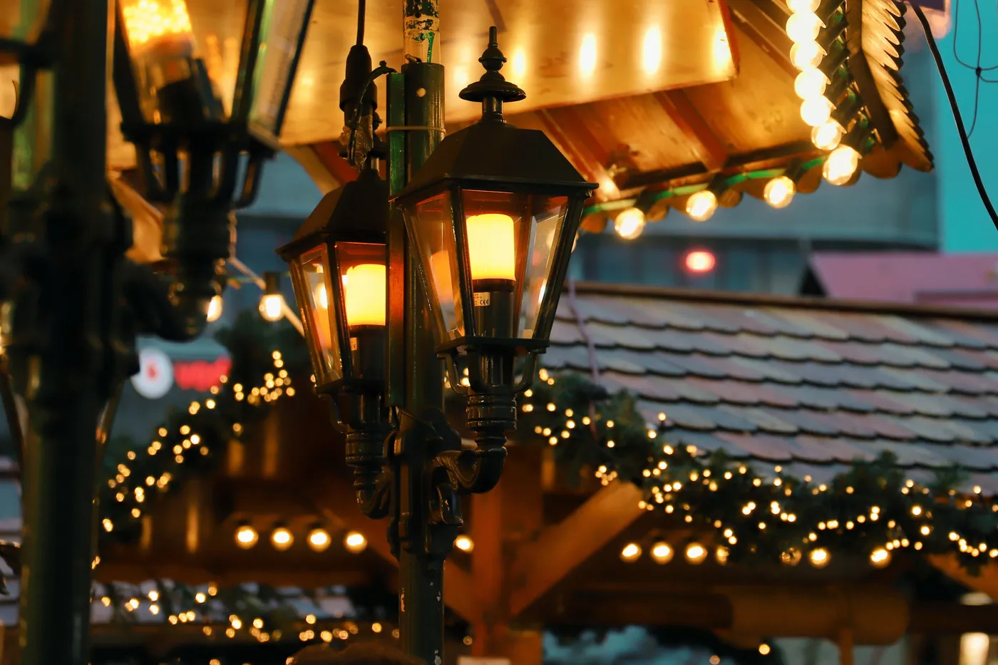 Charming street lanterns illuminate the festive Kassel Christmas market decorated with string lights.