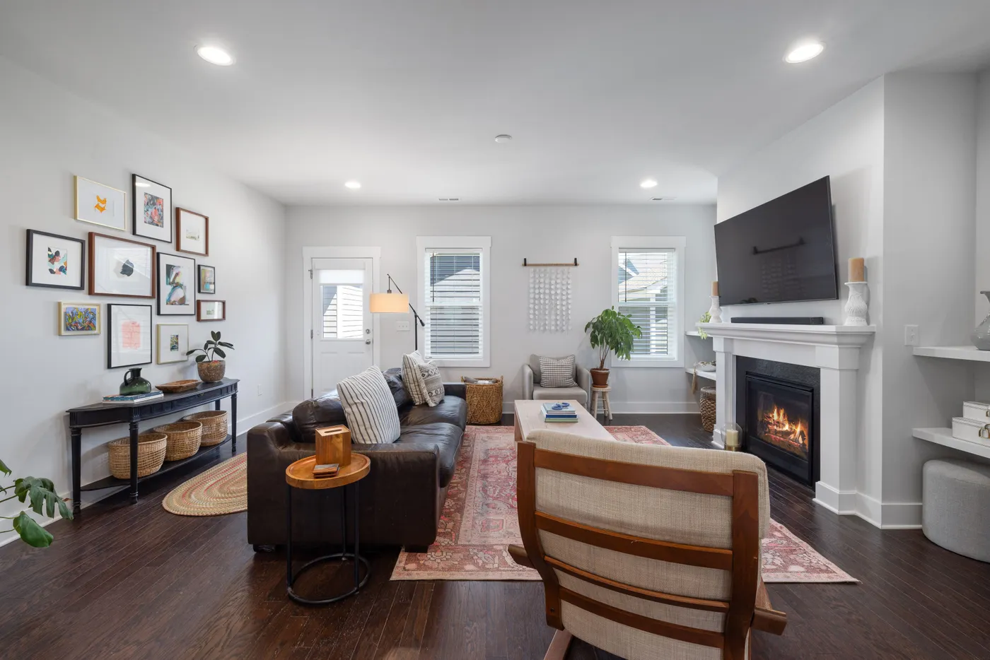 Chic living room interior with modern decor, cozy furniture, and a fireplace, perfect for relaxation.
