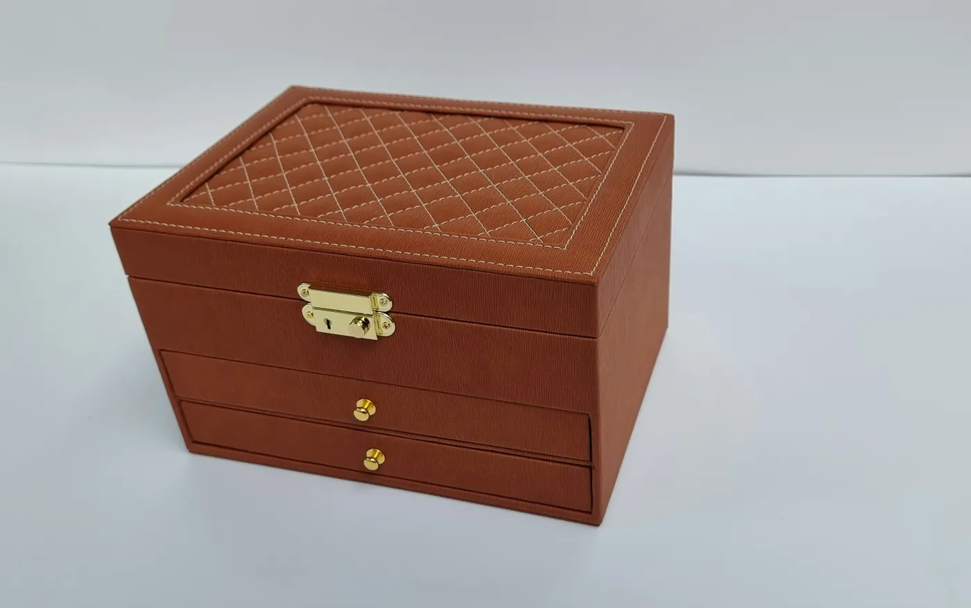 Elegant brown jewelry box with quilted top and gold hardware