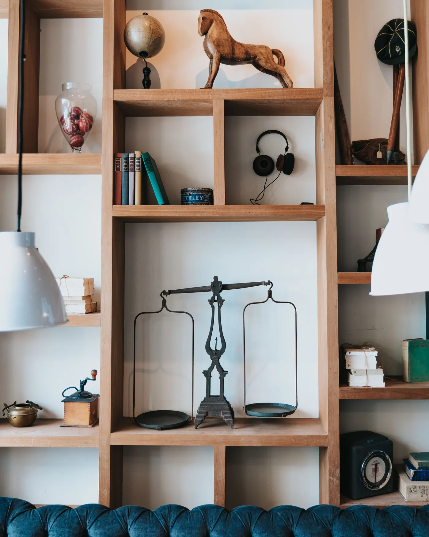 Elegant home interior featuring a wooden bookshelf with various decorative items and books.