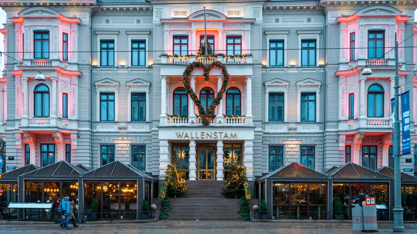 Elegant townhouse entrance adorned with festive lights and heart-shaped decoration during evening time.