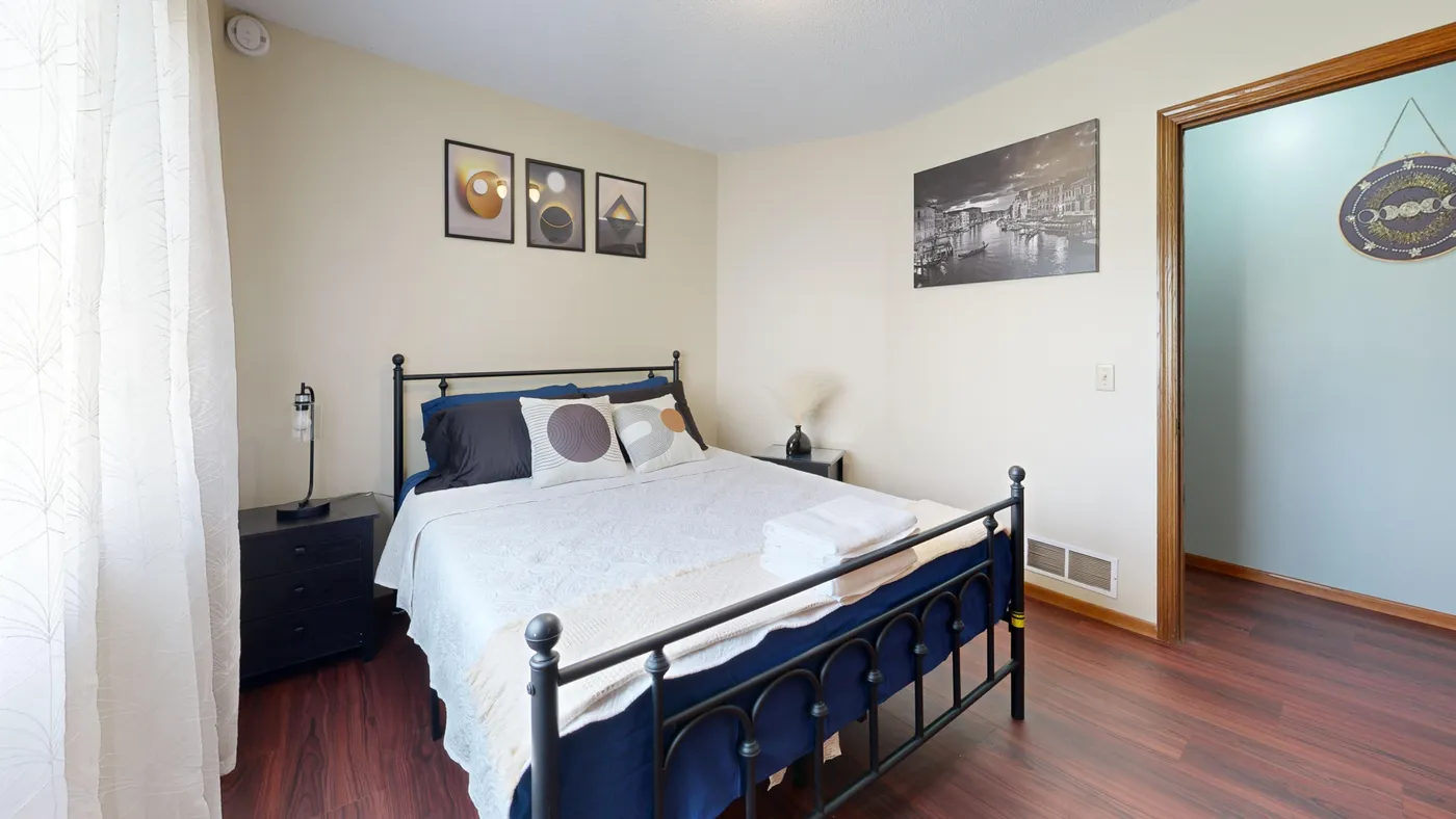 Spacious and inviting modern bedroom with stylish decor and natural lighting.