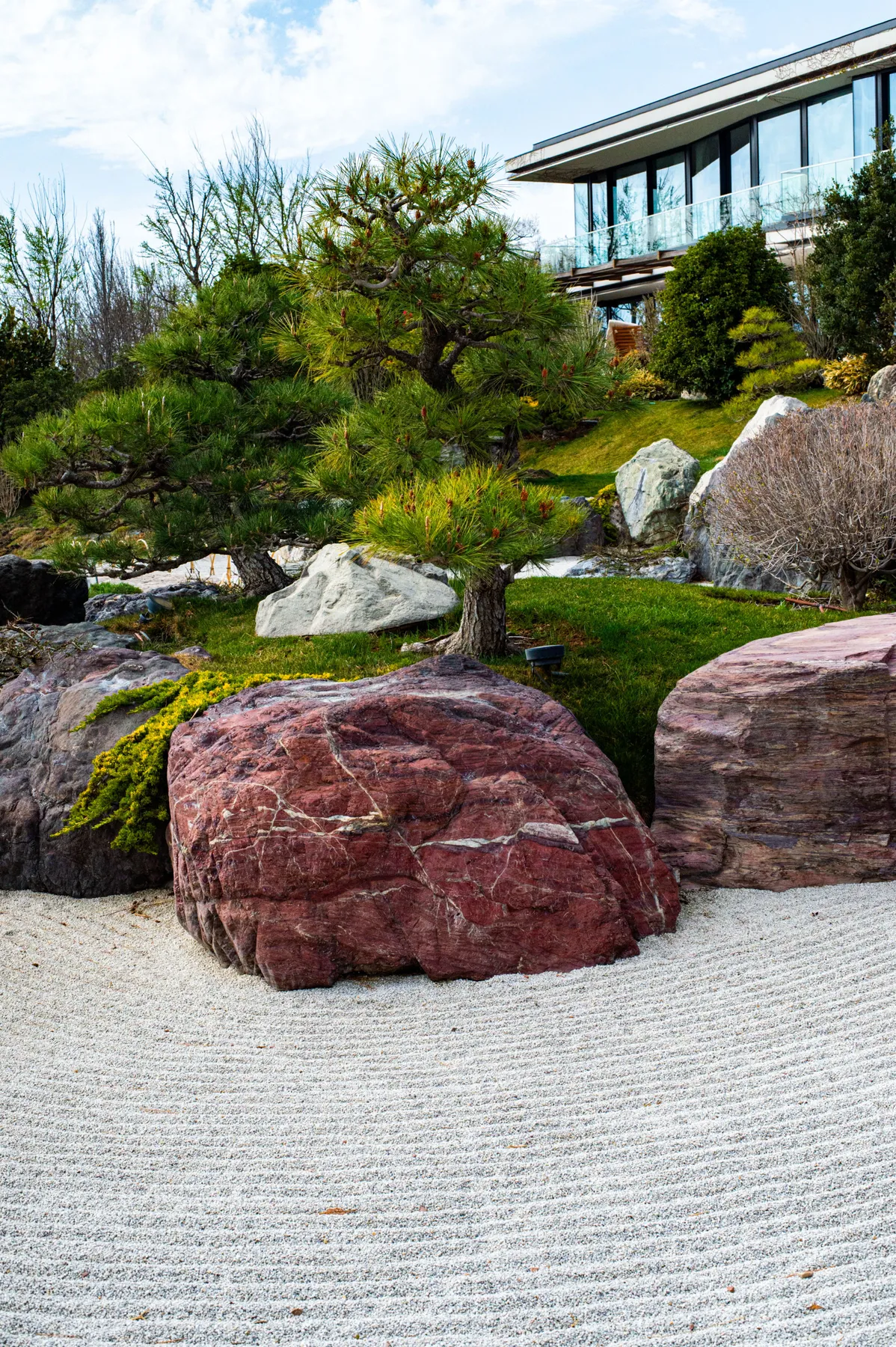 Tranquil Japanese garden landscape featuring rocks and pine trees.