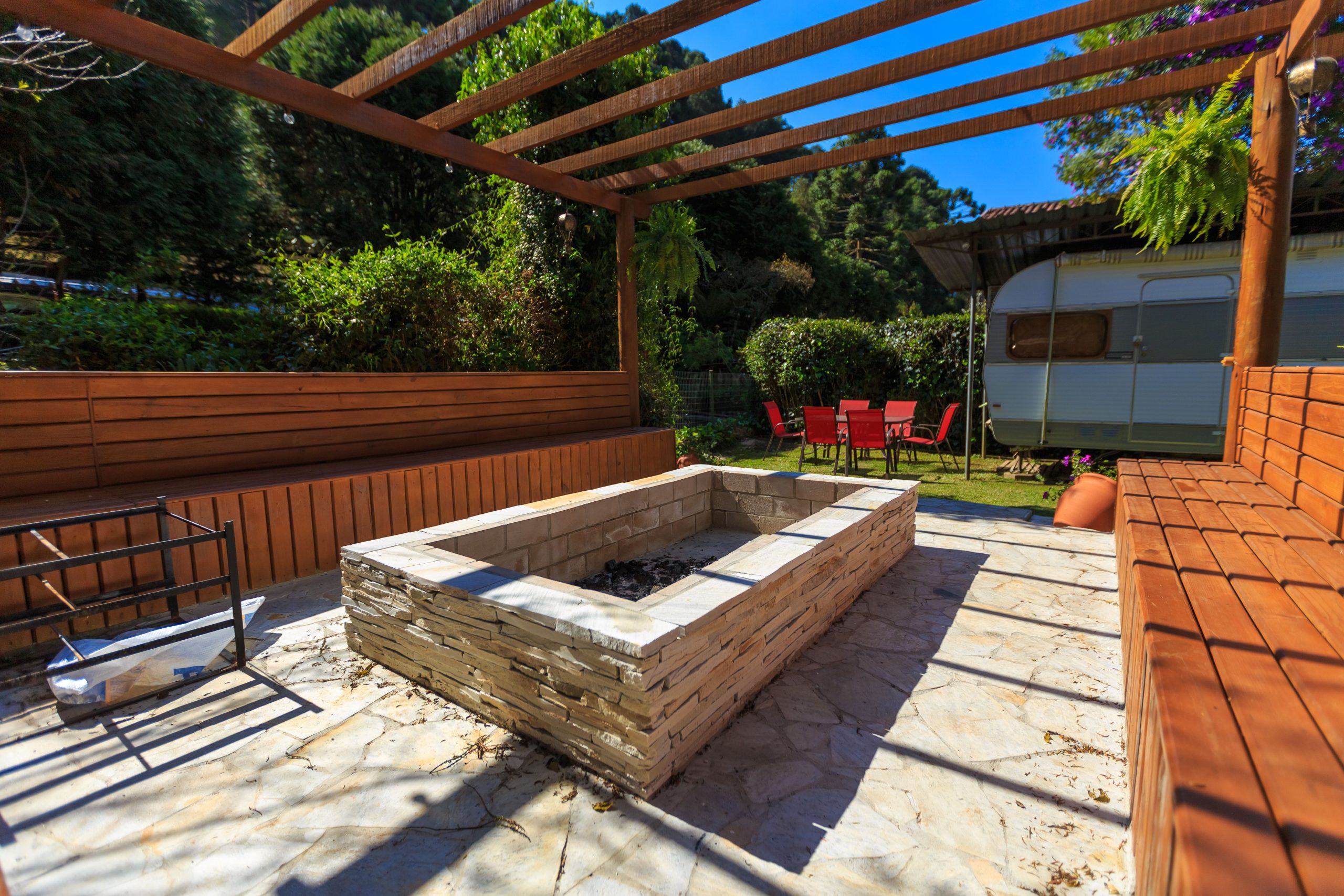 Tranquil outdoor space featuring a fire pit and camper, perfect for summer camping retreats.